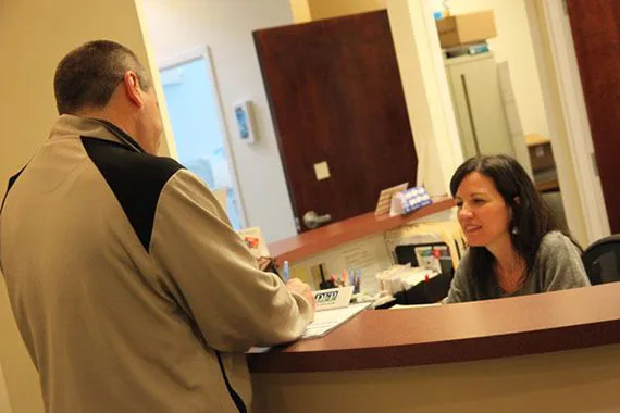 Patient checking in at the front desk